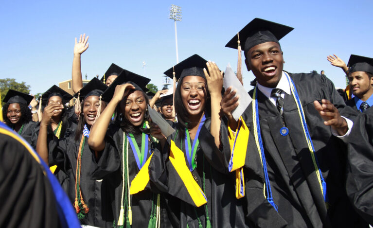 Students react during the graduation ceremony of the 2010 class at Hampton University in Virginia May 9, 2010. U.S. President Barack Obama delivered the commencement address at the graduation and was conferred an honorary doctor of laws degree.     REUTERS/Jason Reed   (UNITED STATES - Tags: POLITICS EDUCATION IMAGES OF THE DAY) - RTR2DNV8